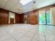 Spacious basement featuring paneled walls, tile flooring, fireplace, and a sliding glass door to outdoors at 460 27Th Avenue Nw Cir, Hickory, NC 28601