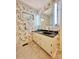 Bathroom with double vanity, floral wallpaper, and neutral tile flooring at 460 27Th Avenue Nw Cir, Hickory, NC 28601