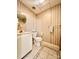 Cozy bathroom featuring tile flooring, toilet, sink, mirror, and striped wallpaper at 460 27Th Avenue Nw Cir, Hickory, NC 28601