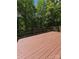 Expansive stained wooden deck showcasing ample space for outdoor furniture and enjoying the natural surroundings at 460 27Th Avenue Nw Cir, Hickory, NC 28601