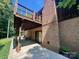 Spacious home with a brick exterior, a covered patio, and a second-story wooden deck at 460 27Th Avenue Nw Cir, Hickory, NC 28601