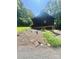 View of home showing a basement garage on a tree covered lot with lush grass at 460 27Th Avenue Nw Cir, Hickory, NC 28601
