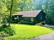 Charming single-story home featuring a well-manicured lawn and beautiful, mature trees surrounding the property at 460 27Th Avenue Nw Cir, Hickory, NC 28601