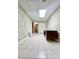 Hallway with tiled floors, vintage wallpaper, and a view of various doors, creating a functional and homey space at 460 27Th Avenue Nw Cir, Hickory, NC 28601