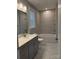 Bathroom featuring grey vanity, marble backsplash, a window, and tub with shower at 9653 Liberty Hill Dr, Mint Hill, NC 28227