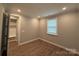 A bright bedroom with laminate floors and a large window providing natural light at 9653 Liberty Hill Dr, Mint Hill, NC 28227