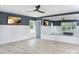 Home gym features a mirrored wall, a ceiling fan, and a white wainscot at 9653 Liberty Hill Dr, Mint Hill, NC 28227