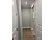 Hallway with wood flooring leads to staircase and rooms with grey wall paint at 9653 Liberty Hill Dr, Mint Hill, NC 28227