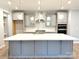 Bright kitchen features a large island, stainless steel appliances, pendant lighting, and gray cabinetry at 9653 Liberty Hill Dr, Mint Hill, NC 28227