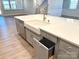 Kitchen island features a farmhouse sink, pull-out trash drawer, dishwasher, and quartz countertops at 9653 Liberty Hill Dr, Mint Hill, NC 28227