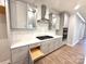 Modern kitchen with gray cabinets, stainless steel appliances, and a white herringbone backsplash at 9653 Liberty Hill Dr, Mint Hill, NC 28227