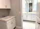 The laundry area features white cabinets and a doorway leading to the bathroom at 9653 Liberty Hill Dr, Mint Hill, NC 28227