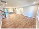 Bright open-concept living room with wood floors and views of the kitchen and backyard at 9653 Liberty Hill Dr, Mint Hill, NC 28227