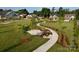 Beautifully landscaped neighborhood with sidewalks, green grass and benches at 9653 Liberty Hill Dr, Mint Hill, NC 28227