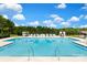 Community pool featuring lounge chairs and umbrellas for residents at 9653 Liberty Hill Dr, Mint Hill, NC 28227