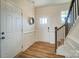 Bright foyer with hardwood floors, white wainscoting, stairs, and a door leading to the garage at 8402 Acadia Pkwy # 351, Sherrills Ford, NC 28673