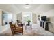 Bright sitting room with two armchairs, a table and decor on a neutral rug and a large, modern painting at 8402 Acadia Pkwy # 351, Sherrills Ford, NC 28673