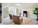 Bright sitting room with two armchairs, a table and decor on a neutral rug and a large, modern painting at 8402 Acadia Pkwy # 351, Sherrills Ford, NC 28673