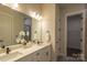 Bright bathroom featuring double sinks, quartz counters, and modern fixtures at 2630 Rose St, Charlotte, NC 28208