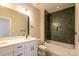 Bright bathroom with white cabinets, granite countertop, and tiled bathtub at 2630 Rose St, Charlotte, NC 28208