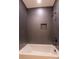 Shower/tub combo with dark gray tile at 2630 Rose St, Charlotte, NC 28208