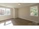 Bedroom featuring wood-look floors, neutral paint and windows offering verdant views at 2630 Rose St, Charlotte, NC 28208