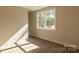 Bright bedroom with natural light, neutral paint, wood-look floors and large window at 2630 Rose St, Charlotte, NC 28208