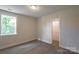 Neutral-painted bedroom featuring wood-look floors and window offering verdant views at 2630 Rose St, Charlotte, NC 28208