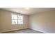 Neutral-painted bedroom featuring wood-look floors and window offering verdant views at 2630 Rose St, Charlotte, NC 28208