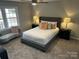 Comfortable bedroom with a ceiling fan, carpet, and natural light from the window overlooking the yard at 2630 Rose St, Charlotte, NC 28208