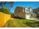 Well-maintained home exterior with attached garage and landscaped yard, enclosed by a wooden fence at 2630 Rose St, Charlotte, NC 28208