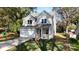 Two-story house with light beige siding, white garage door, and landscaped yard at 2630 Rose St, Charlotte, NC 28208