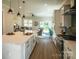 Open kitchen with white cabinets, quartz countertops, stainless steel appliances, and seamless flow to the living area at 2630 Rose St, Charlotte, NC 28208