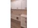 Laundry room featuring white cabinets, modern fixtures, and tile floors at 2630 Rose St, Charlotte, NC 28208