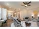 Spacious living room with gray sofa, ceiling fan, and large windows at 2630 Rose St, Charlotte, NC 28208