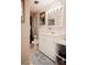 Bright bathroom featuring a large vanity, decorative mirror and lights, and functional toilet with nearby storage at 3021 Davis Park Rd, Gastonia, NC 28052