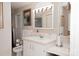 Clean bathroom featuring a large vanity, decorative mirror and lights, and functional toilet with nearby storage at 3021 Davis Park Rd, Gastonia, NC 28052