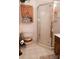 A bathroom with a shower, toilet and cabinet storage at 3021 Davis Park Rd, Gastonia, NC 28052
