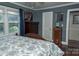 Relaxing bedroom featuring blue walls, wood floors, and bright natural light from the windows at 3021 Davis Park Rd, Gastonia, NC 28052