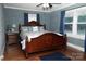 Cozy bedroom with a large wood bed frame, wood floors, and natural light at 3021 Davis Park Rd, Gastonia, NC 28052
