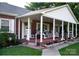 Spacious covered porch with plenty of seating, perfect for enjoying the outdoors and entertaining guests at 3021 Davis Park Rd, Gastonia, NC 28052