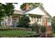 Beautiful home exterior with a sprawling porch, lush landscaping, and brick accents at 3021 Davis Park Rd, Gastonia, NC 28052