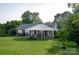 Charming brick home featuring a welcoming front porch and beautifully maintained lawn and landscaping at 3021 Davis Park Rd, Gastonia, NC 28052
