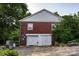 Exterior of a two-car garage featuring a brick facade and white doors at 3021 Davis Park Rd, Gastonia, NC 28052
