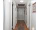 Bright hallway featuring a wooden floor, neutral colored walls and multiple doors leading to other rooms at 3021 Davis Park Rd, Gastonia, NC 28052