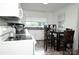 Bright kitchen with dark countertops, white cabinets, and cozy dining area with chairs at 3021 Davis Park Rd, Gastonia, NC 28052