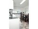 Well-lit kitchen with dark countertops, white cabinets, and cozy dining area with chairs at 3021 Davis Park Rd, Gastonia, NC 28052