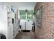 Functional laundry room with appliances, storage shelves, and natural light from windows, blending utility with comfort at 3021 Davis Park Rd, Gastonia, NC 28052