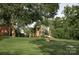 Charming outbuilding with a covered porch, set in a well-manicured backyard, offering versatile space at 3021 Davis Park Rd, Gastonia, NC 28052