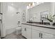 A stylish bathroom featuring a double vanity, framed mirrors, decorative tile flooring, and modern lighting at 5216 Mint Harbor Way # 0284, Charlotte, NC 28269